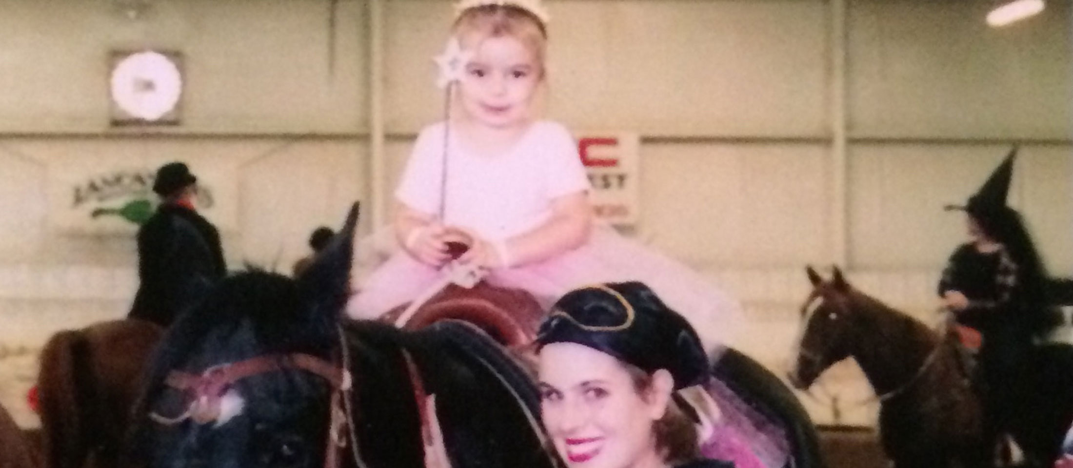 Childhood photo of Hailey Frederiksen sitting on a horse.